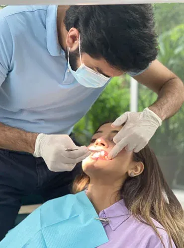 A dentist checking a patient's teeth