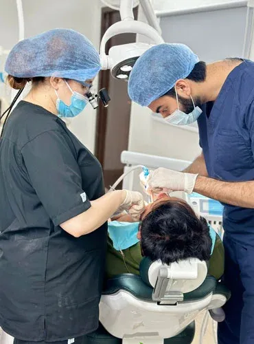 The surgical team in scrubs treating a patient